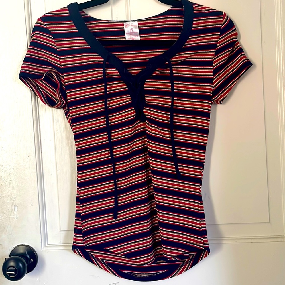 T-shirt the is red,white,blue, and tan colored stripes